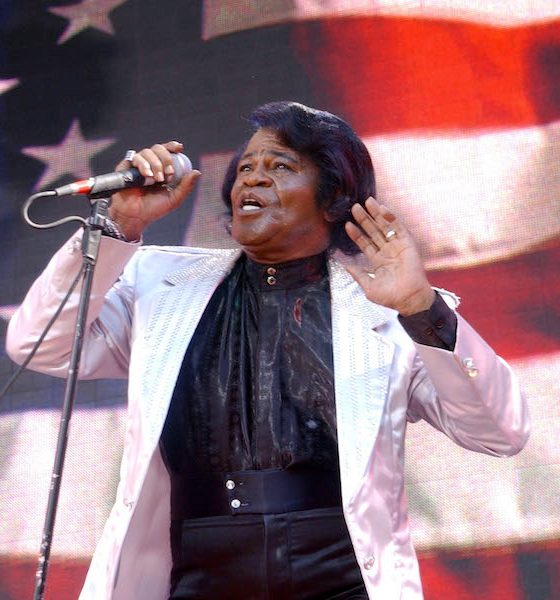 James Brown, singer of the patriotic song and 4th of July anthem Living in America, singing in front of an American flag