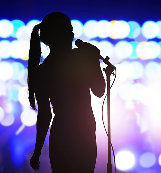 Karaoke singer singing songs into microphone